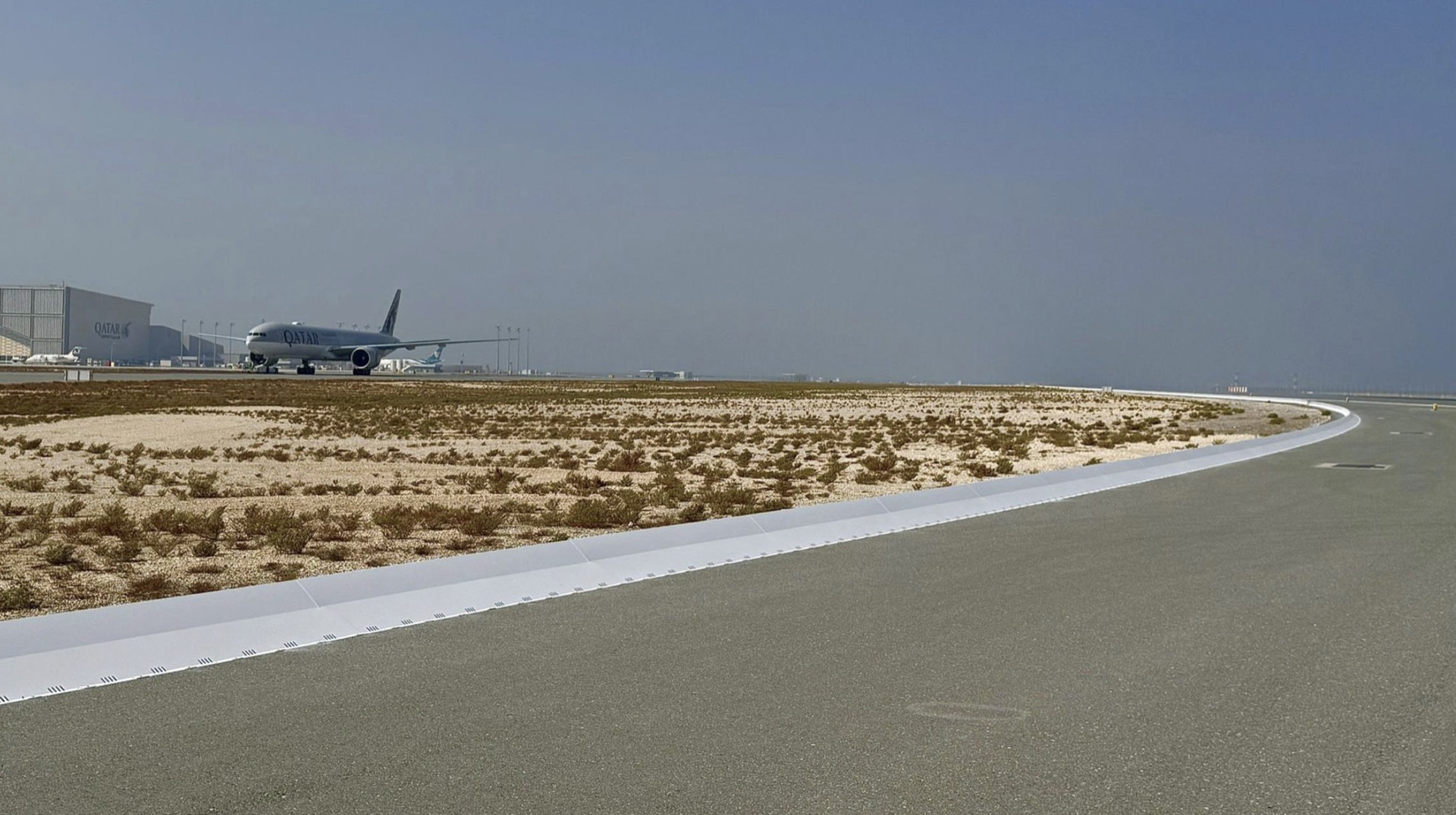 Commercial airport runway safety system with collapsible FOD barrier preventing aircraft engine damage