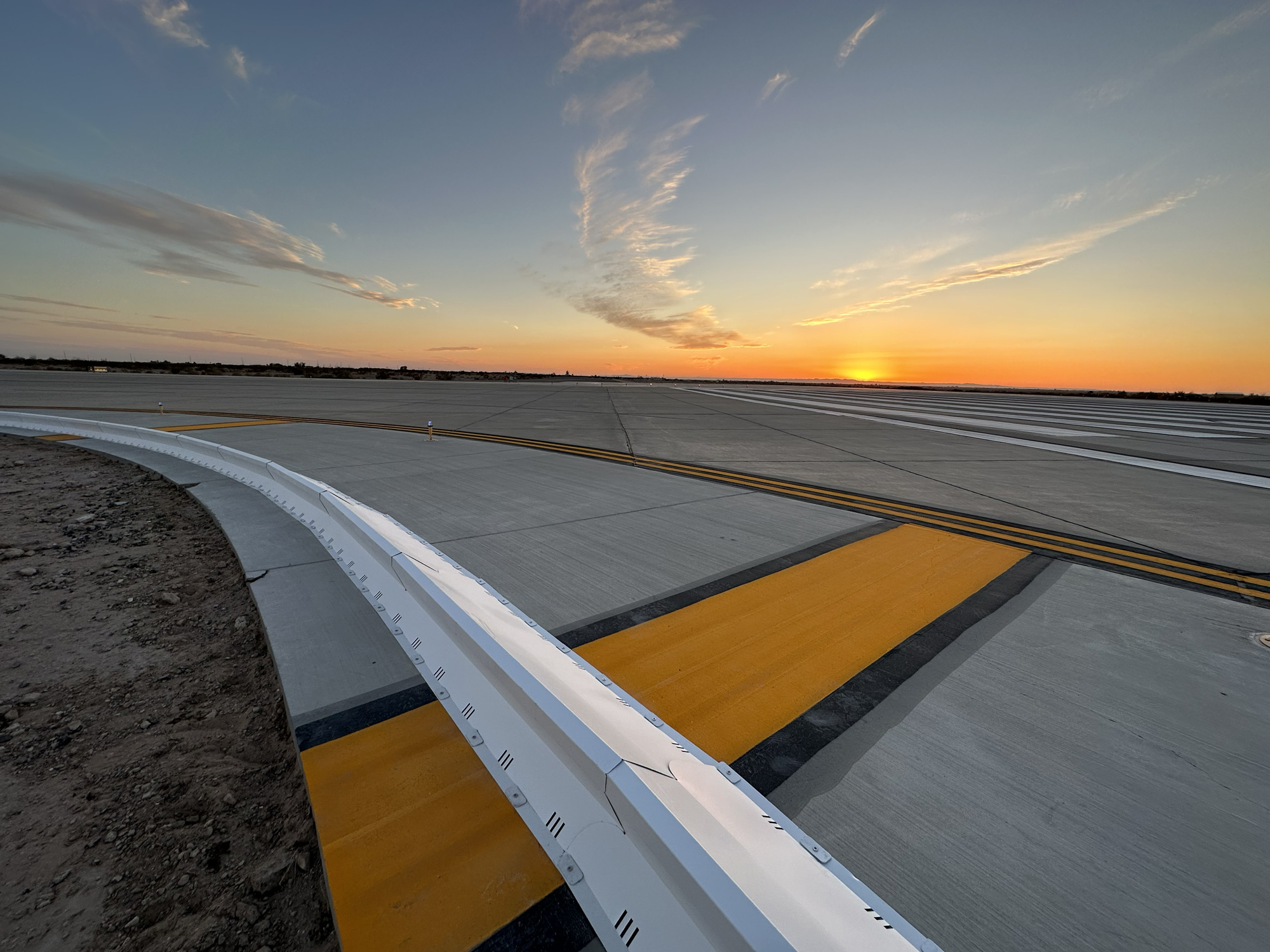 Commercial airport runway safety system with collapsible FOD barrier preventing aircraft engine damage