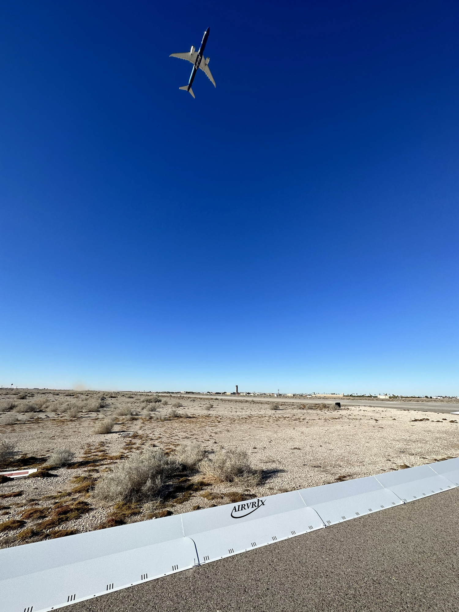 Commercial airport runway safety system with collapsible FOD barrier preventing aircraft engine damage