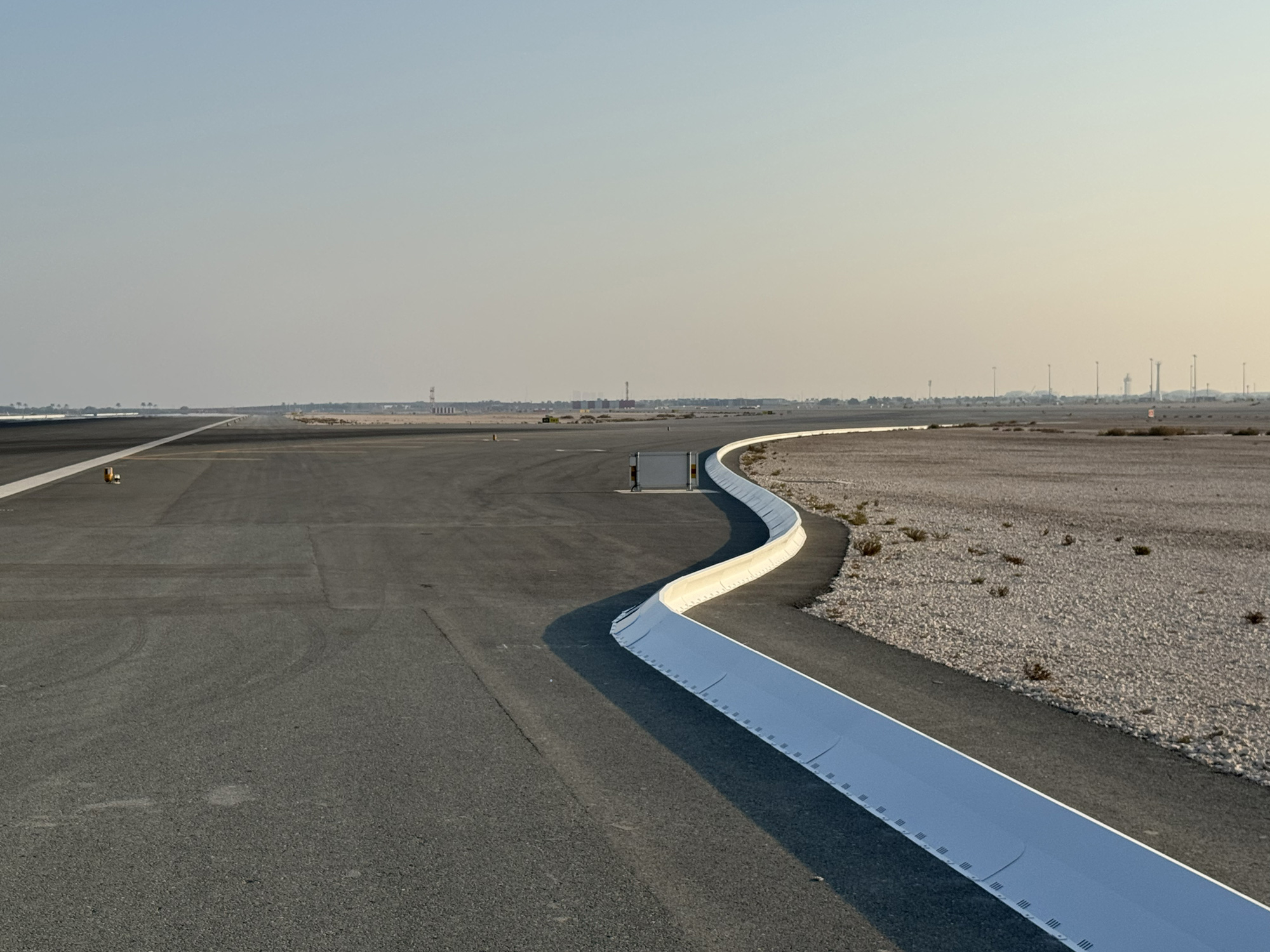 Commercial airport runway safety system with collapsible FOD barrier preventing aircraft engine damage